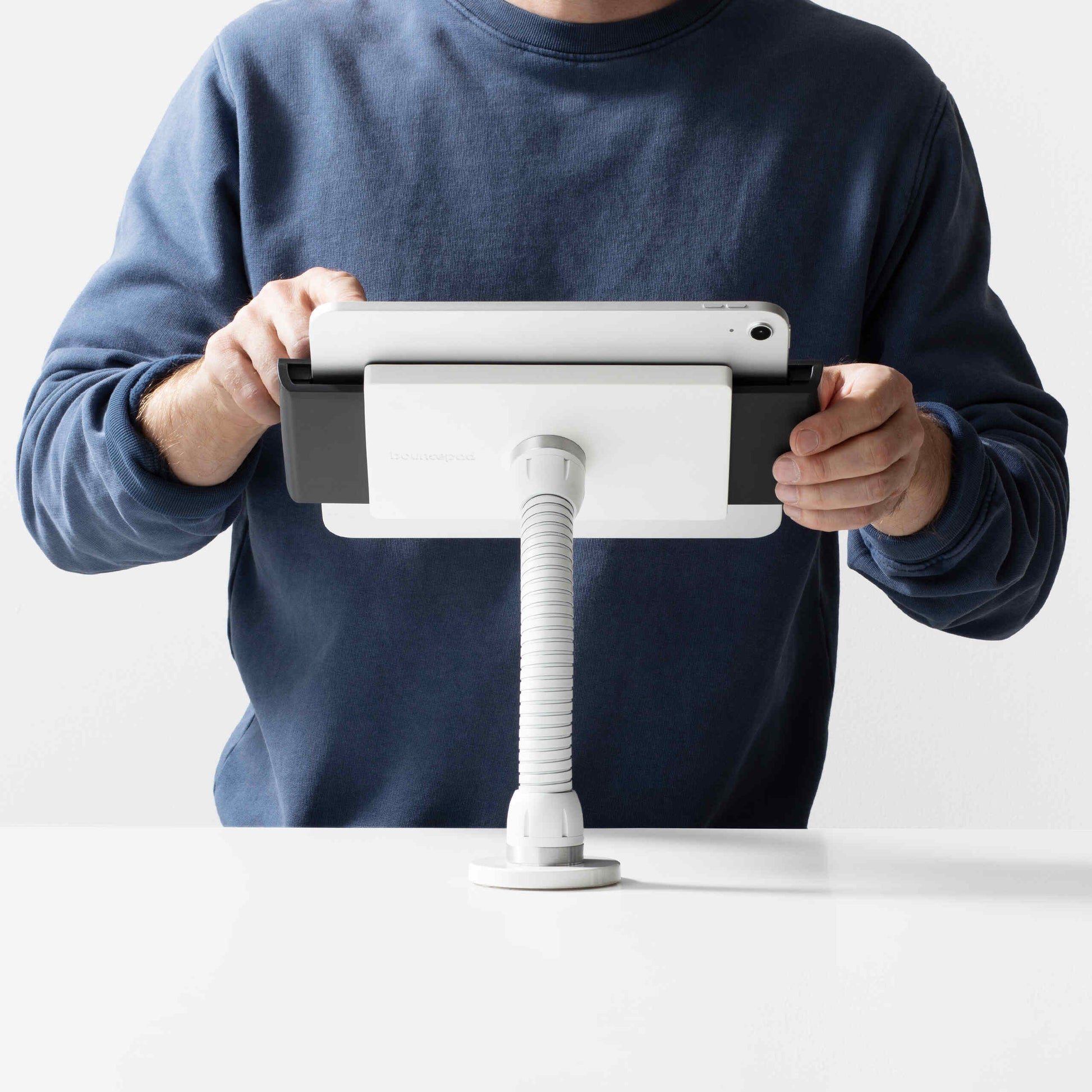 Bouncepad Clip Flex Tablet Desk Mount in white, shown in use