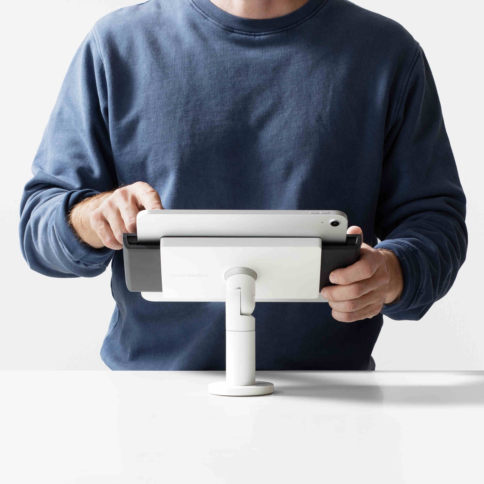 Bouncepad Clip Twist-Mini Tablet Desk Mount in white, front view, shown in use