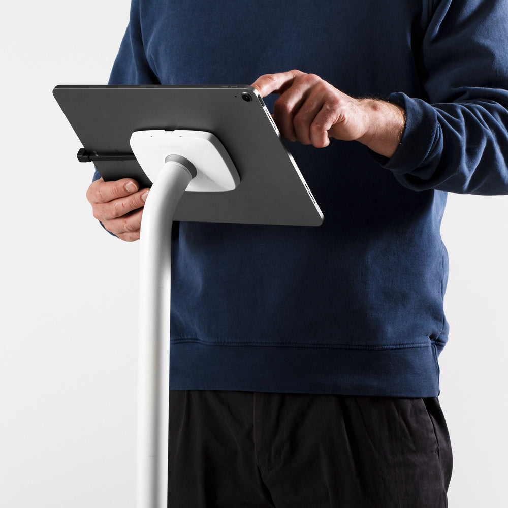 Bouncepad Core Elevate Slim Tablet Floor Stand in white, shown in use