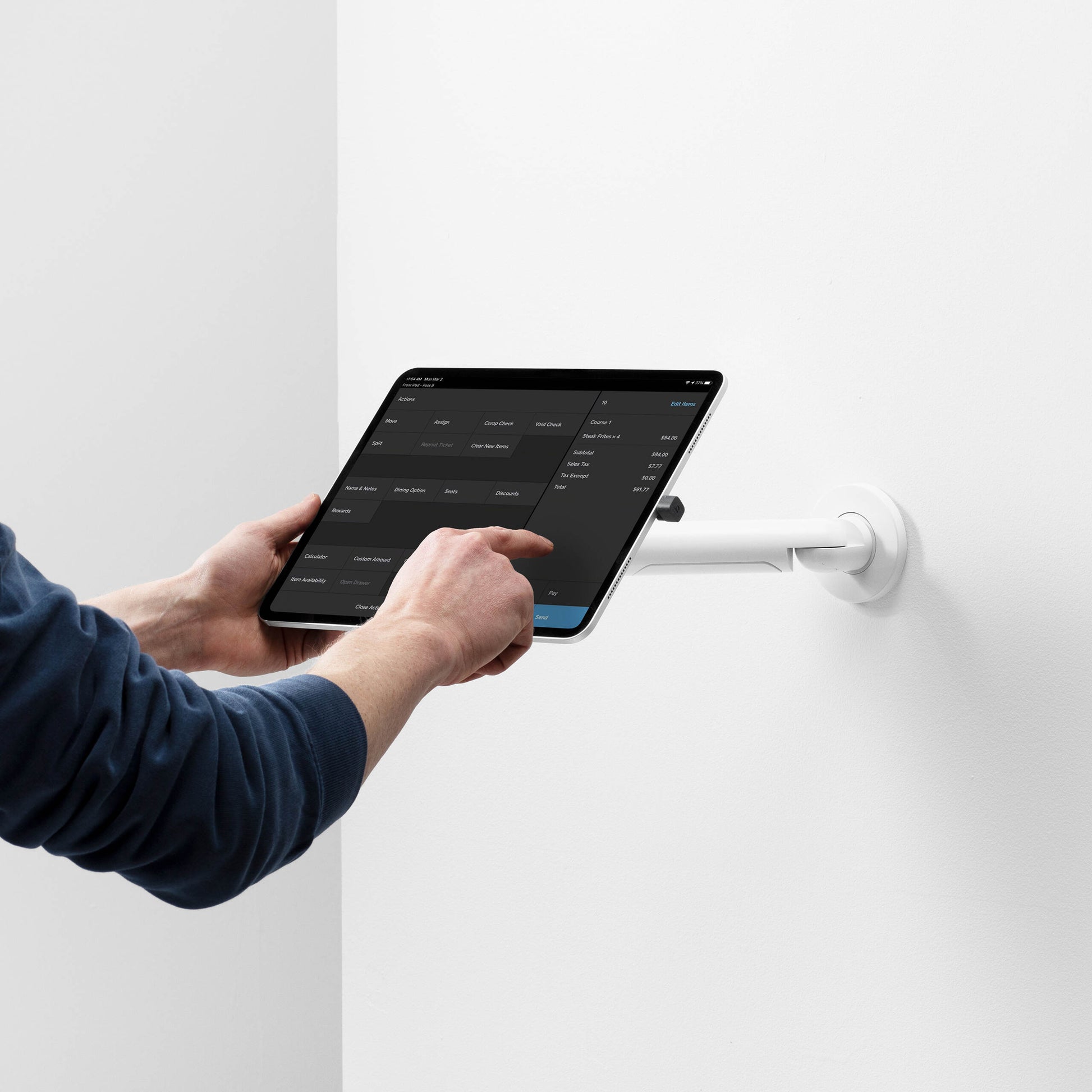 Bouncepad Core Reach Tablet Wall Mount in white, shown in use