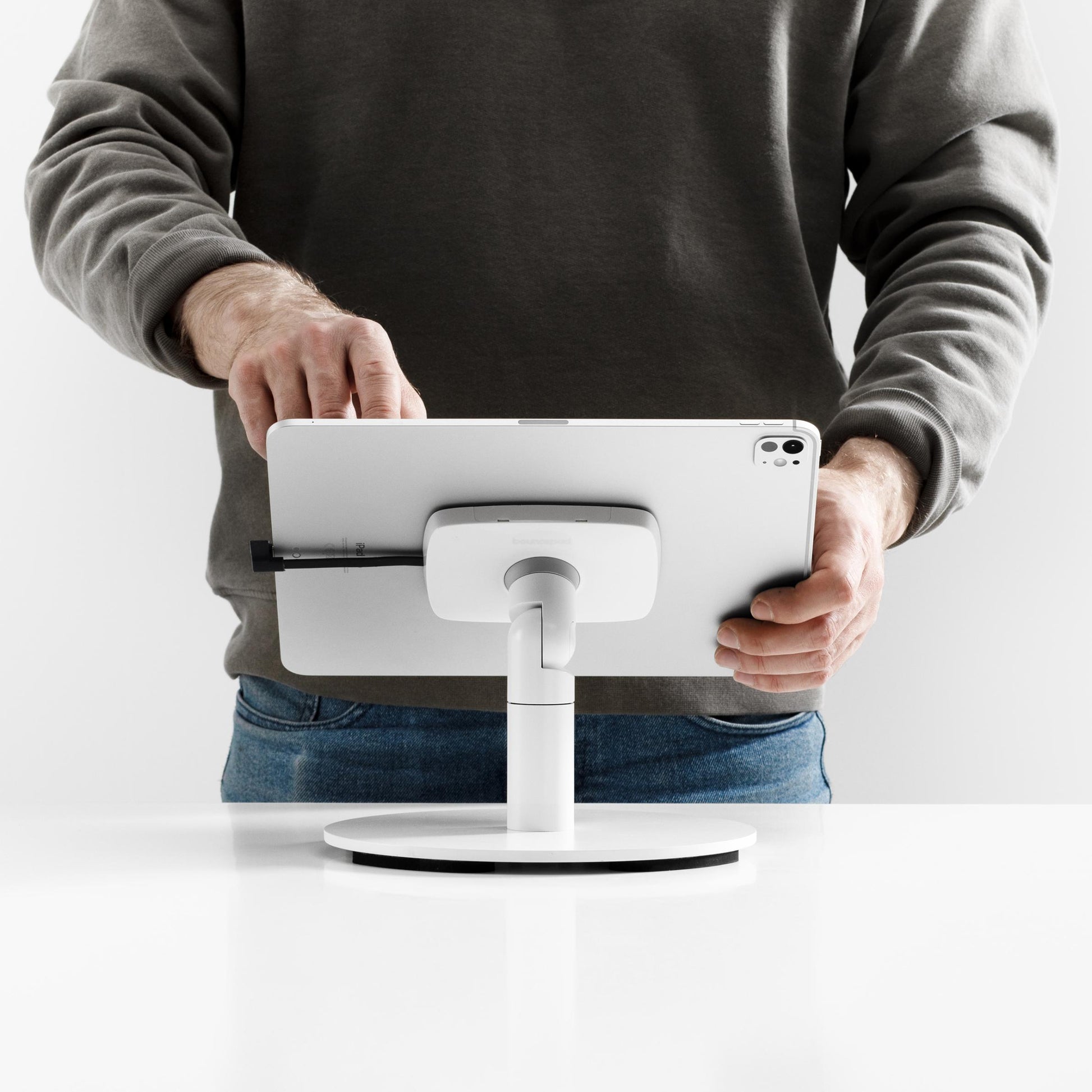 Bouncepad Core Counter Twist-Mini Tablet Stand in white, shown in use