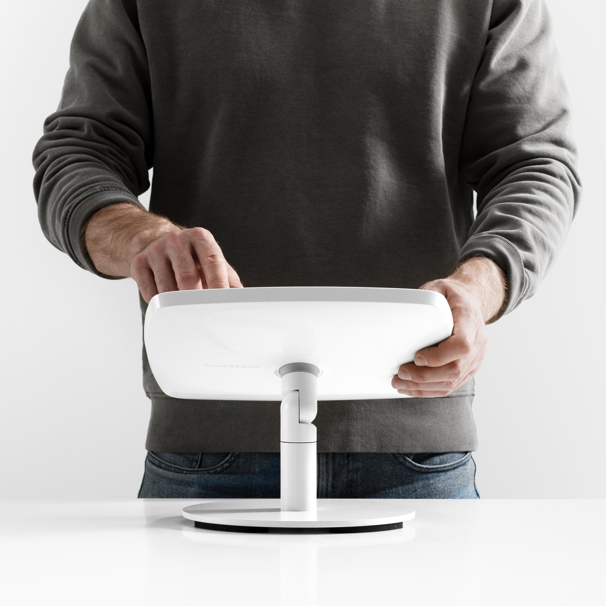 Bouncepad Original Counter Twist-Mini Tablet Stand in white, shown in use