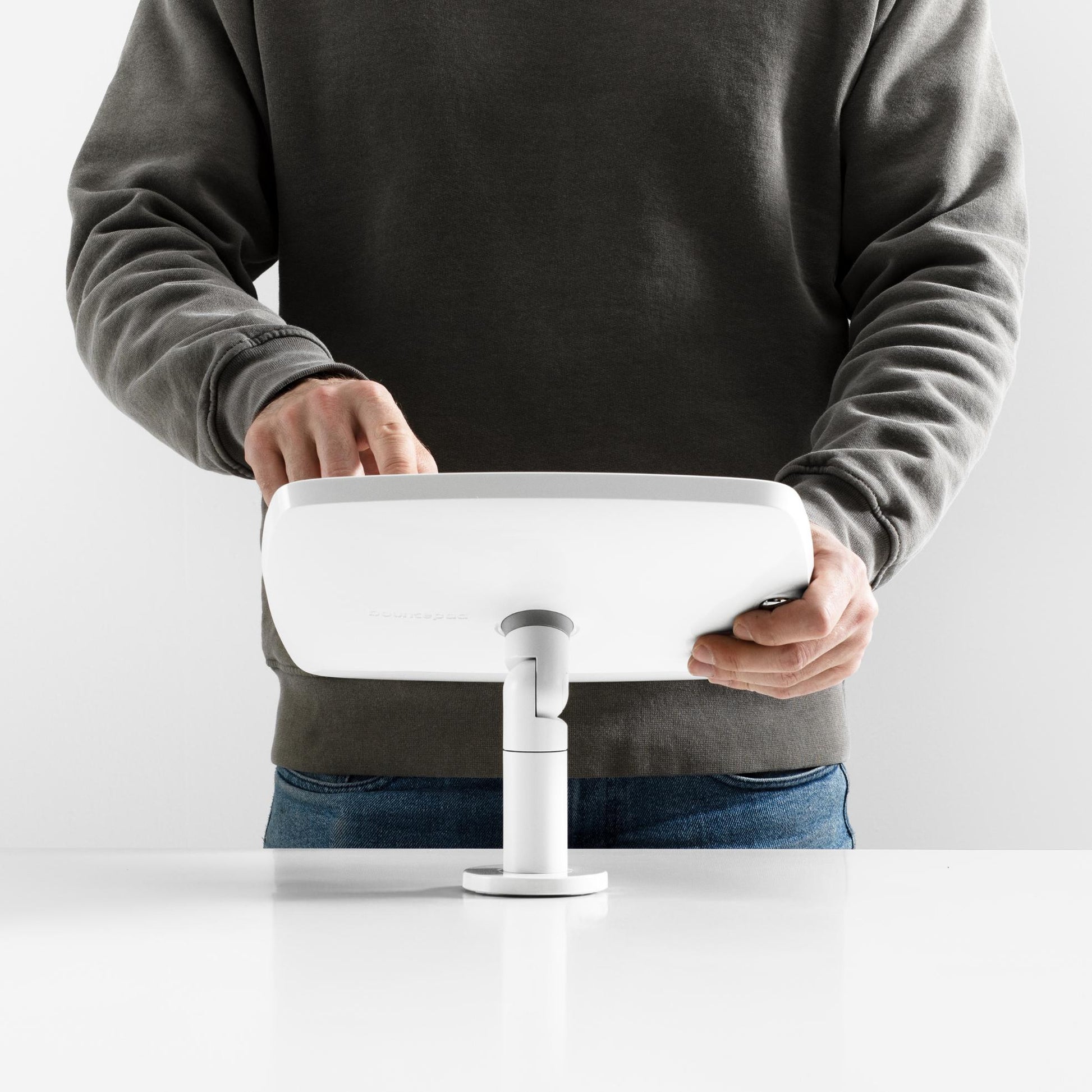 Bouncepad Original Twist-Mini Tablet Desk Mount in white, shown in use